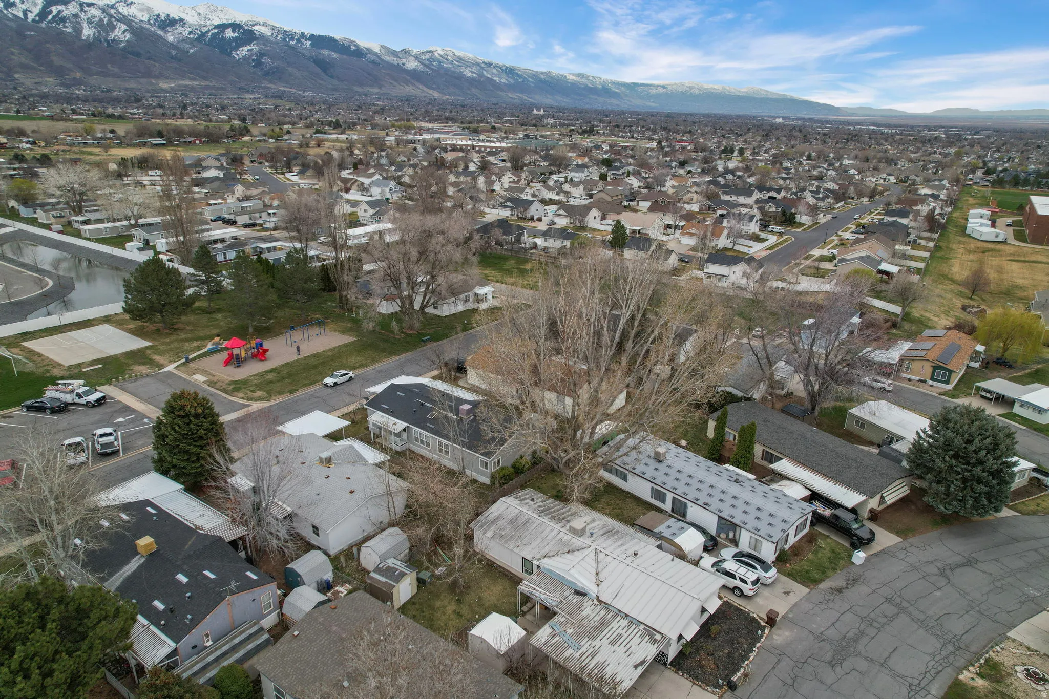 Aerial view of property's location with nearby suburban area and a mountain backdrop