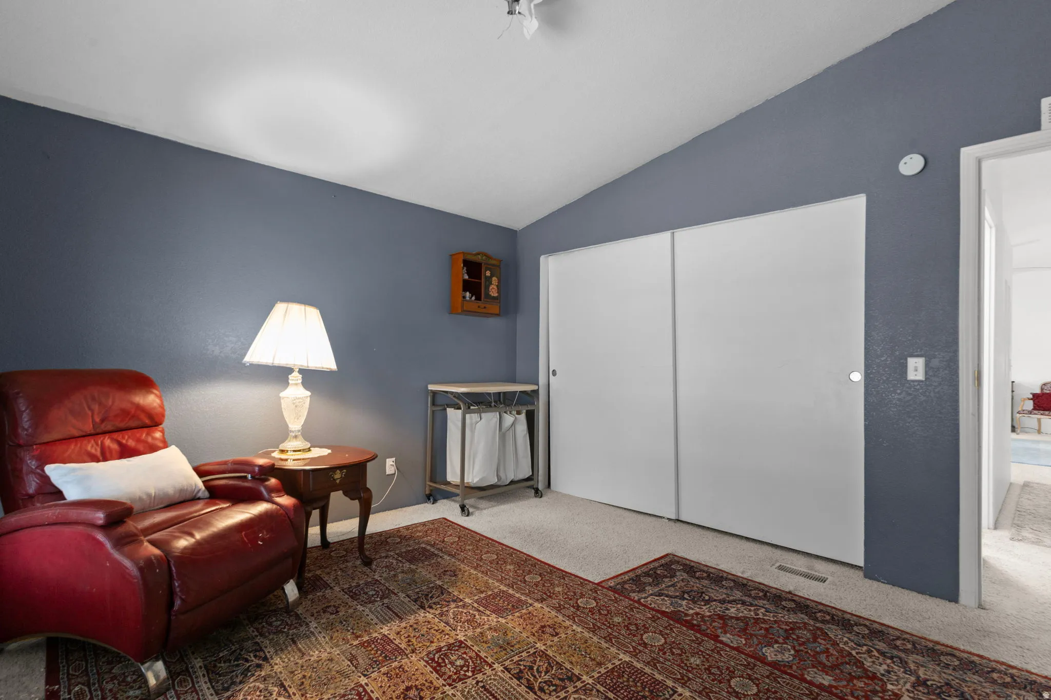 Sitting room with lofted ceiling and carpet floors