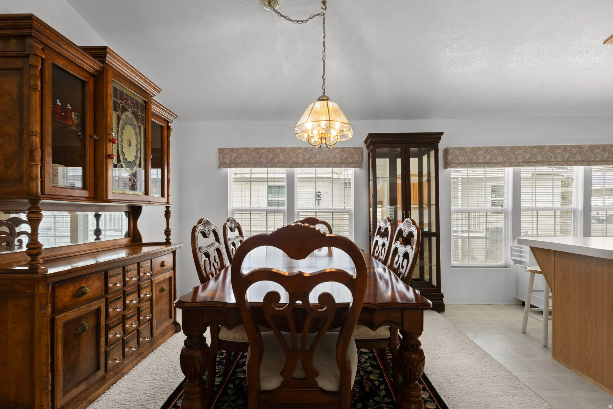Dining room featuring light flooring, plenty of natural light, and a chandelier