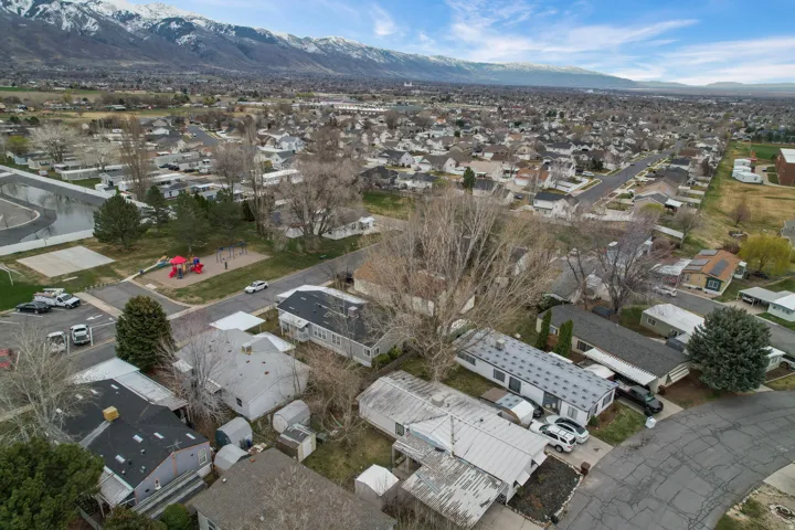 Aerial view of property's location with nearby suburban area and a mountain backdrop