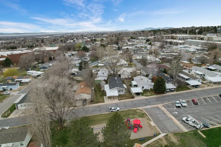 Aerial view of property's location featuring nearby suburban area and a mountain backdrop