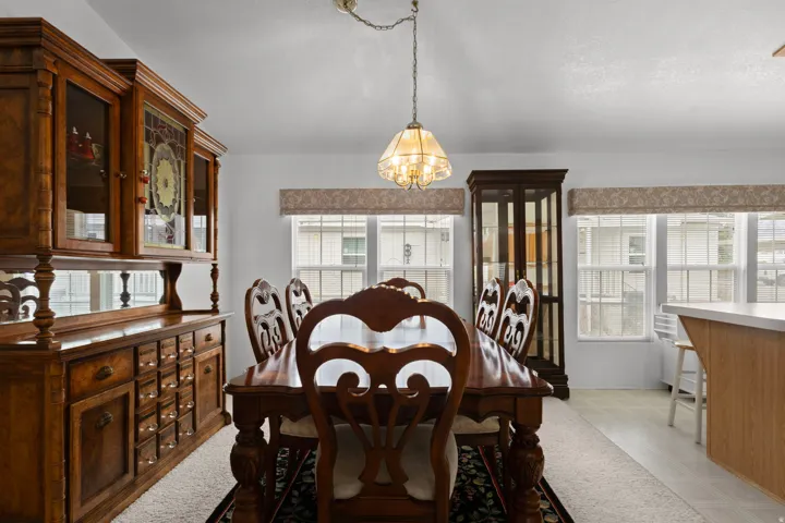 Dining room featuring light flooring, plenty of natural light, and a chandelier