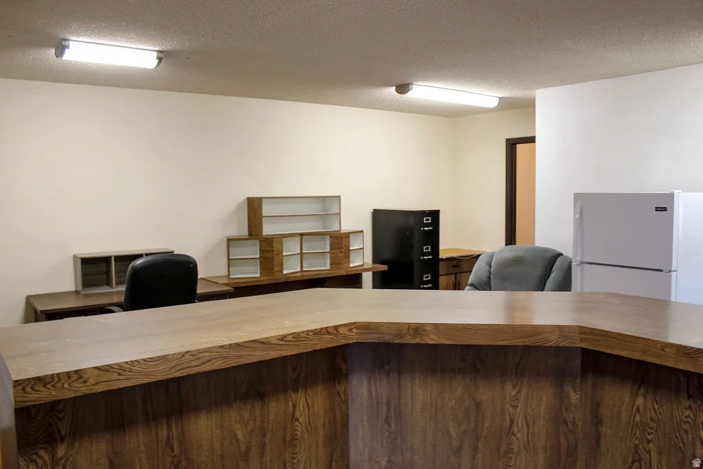 Office area featuring a textured ceiling