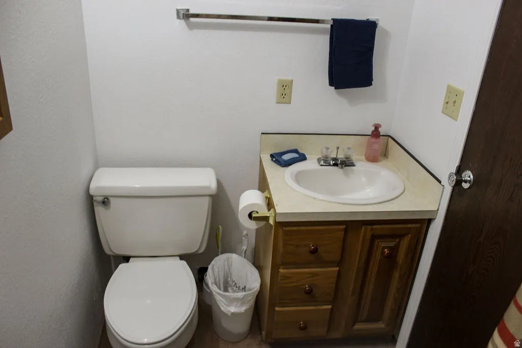 Half bathroom with vanity and toilet