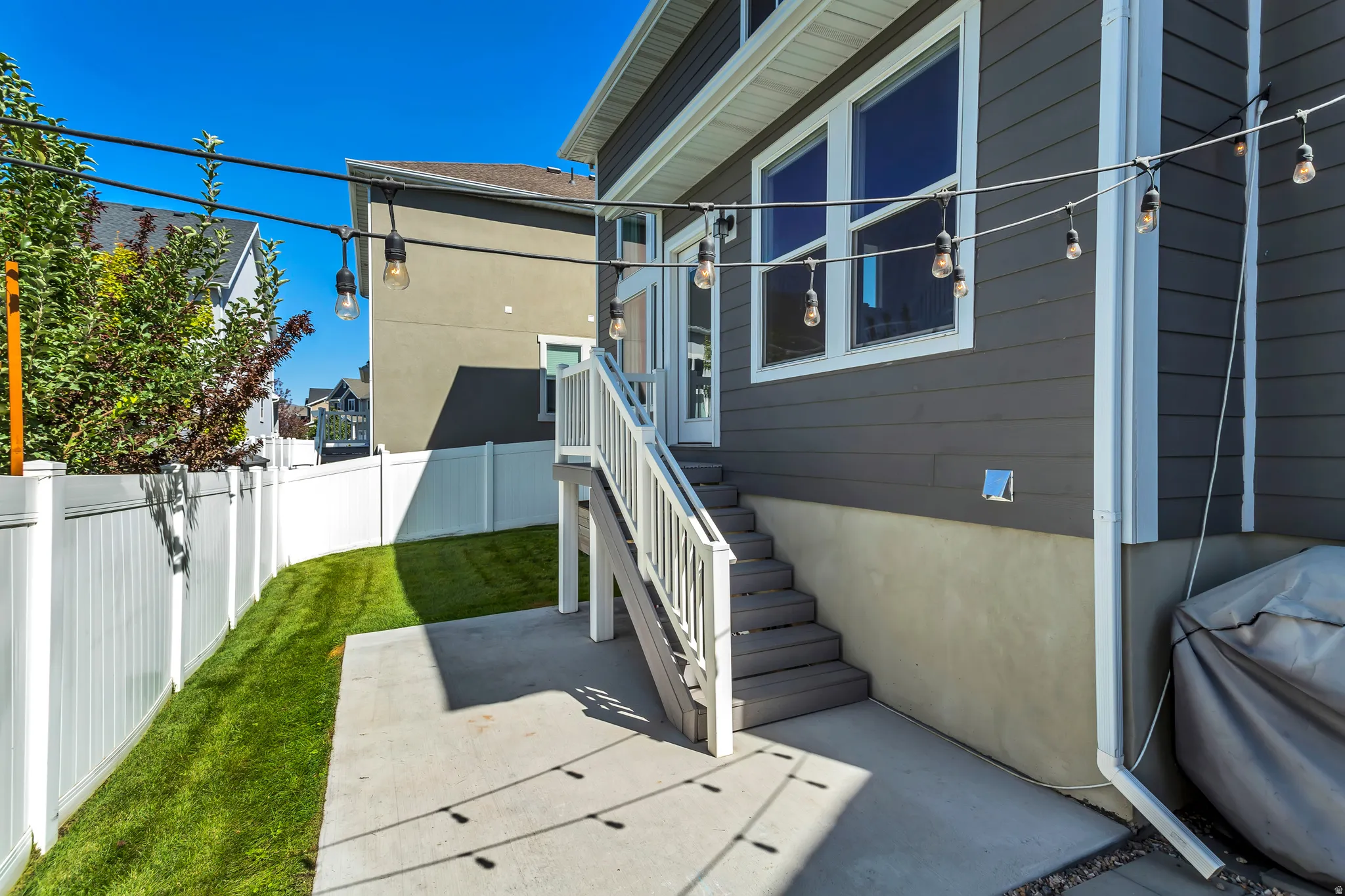 View of property exterior featuring a fenced backyard and a patio