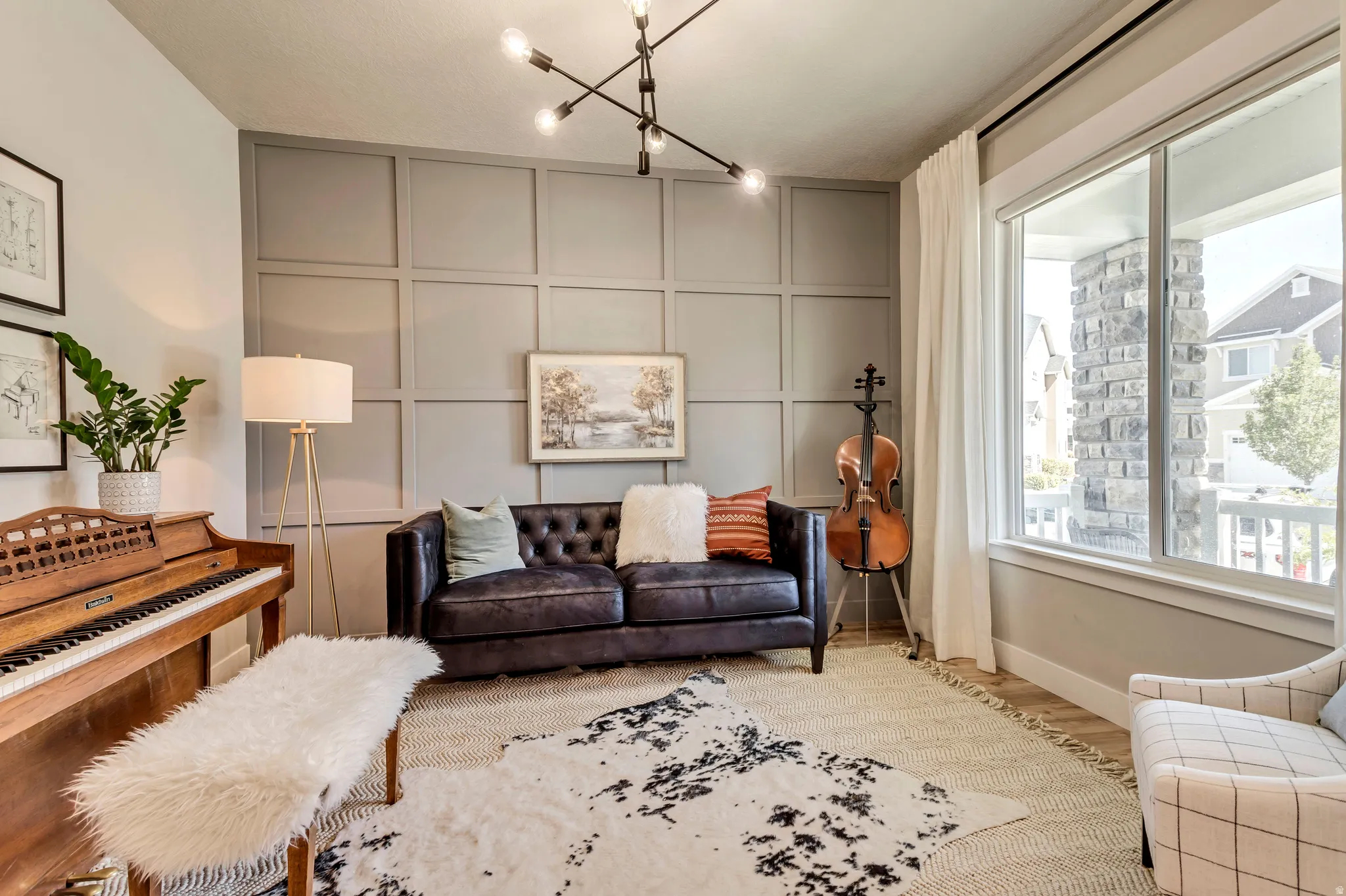Living area with a decorative wall, wood finished floors, and track lighting