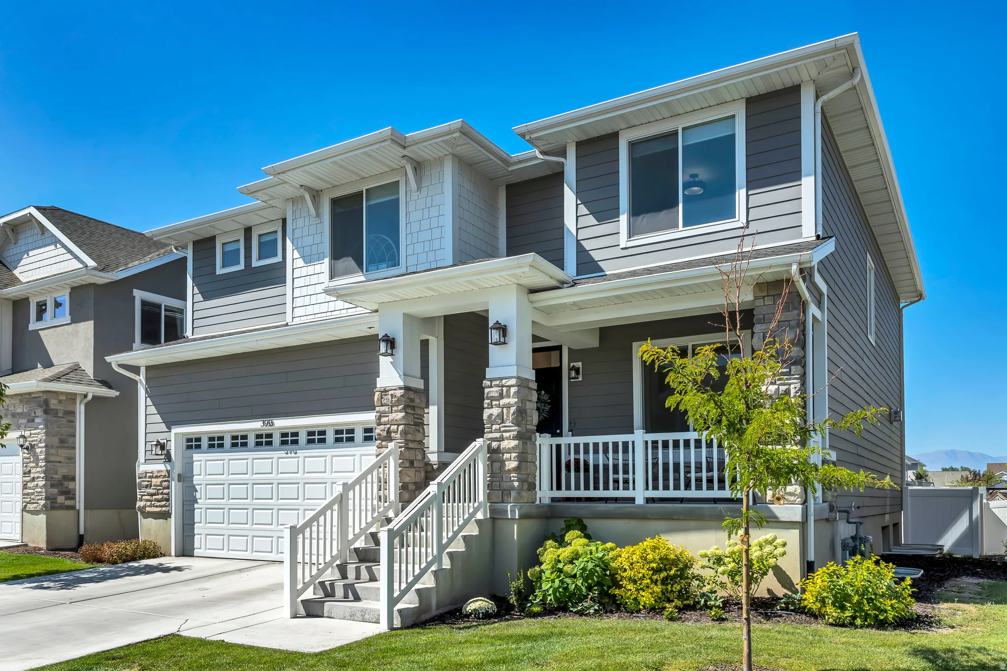 View of front of house with a garage, covered porch, and concrete driveway