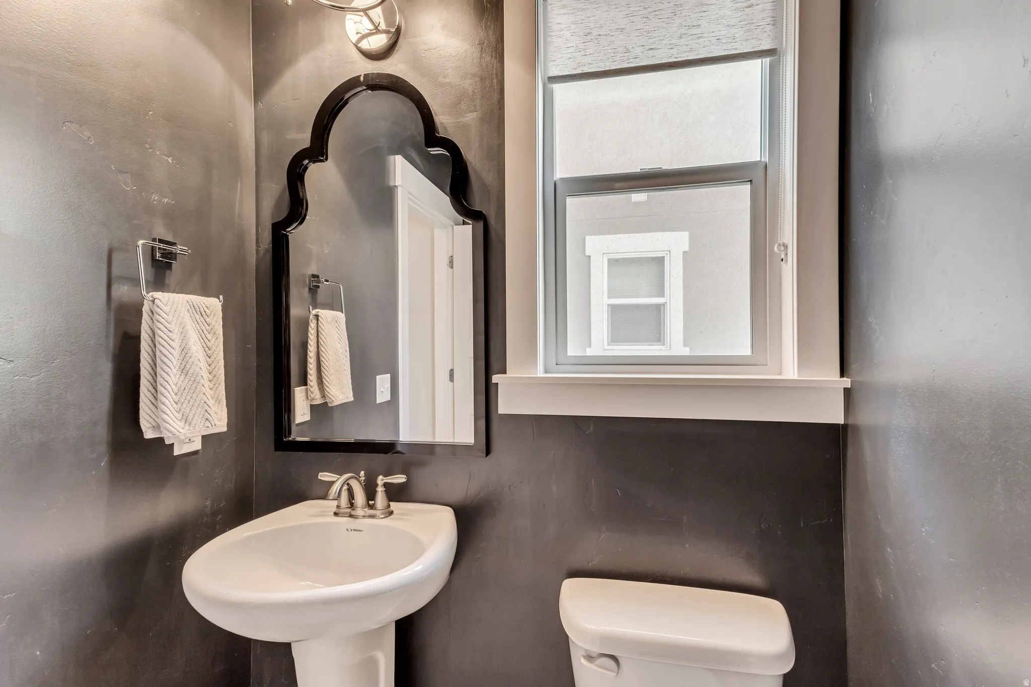 Half bathroom with toilet and a sink