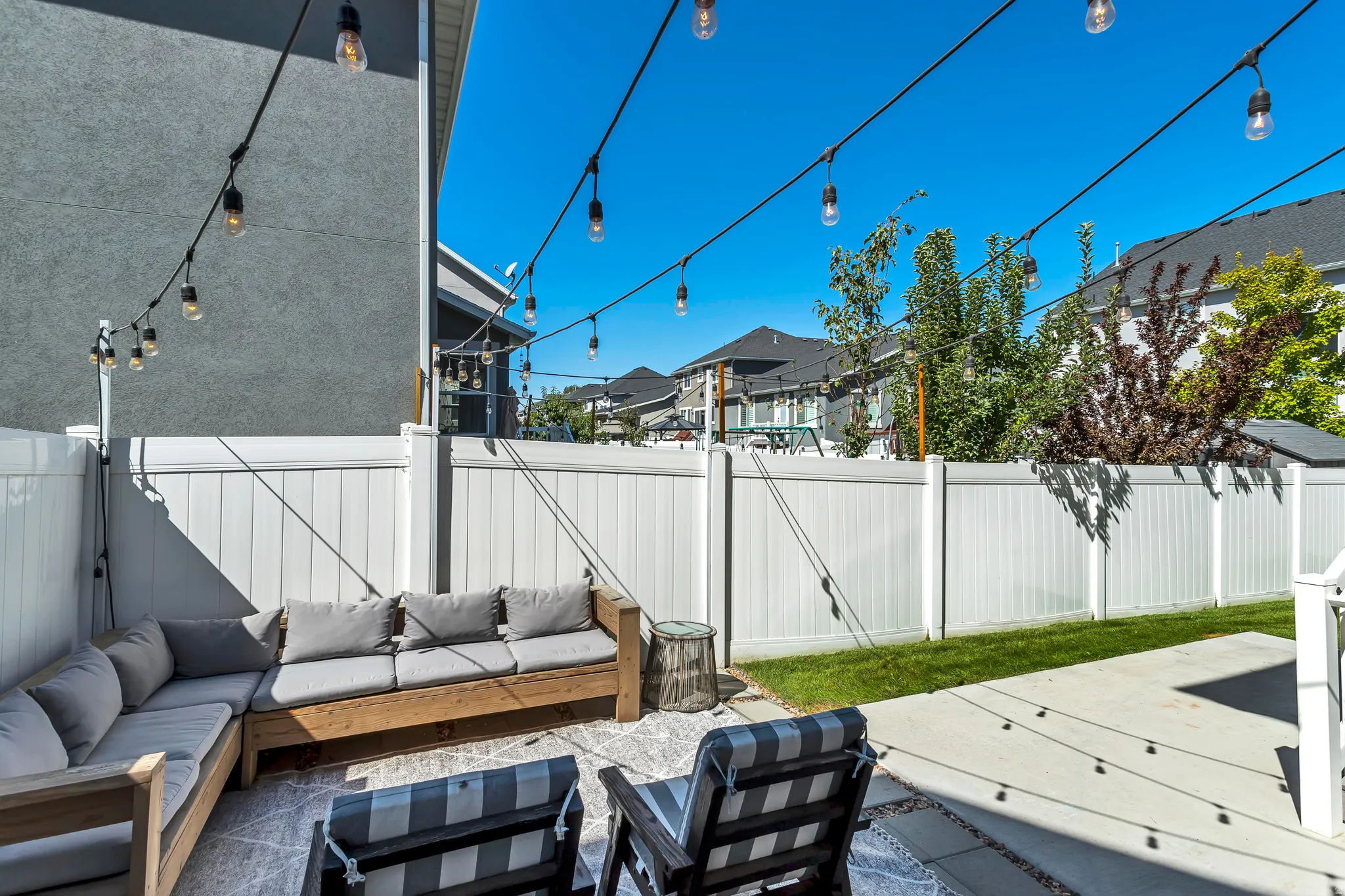 Fenced backyard featuring a patio and an outdoor lounge area