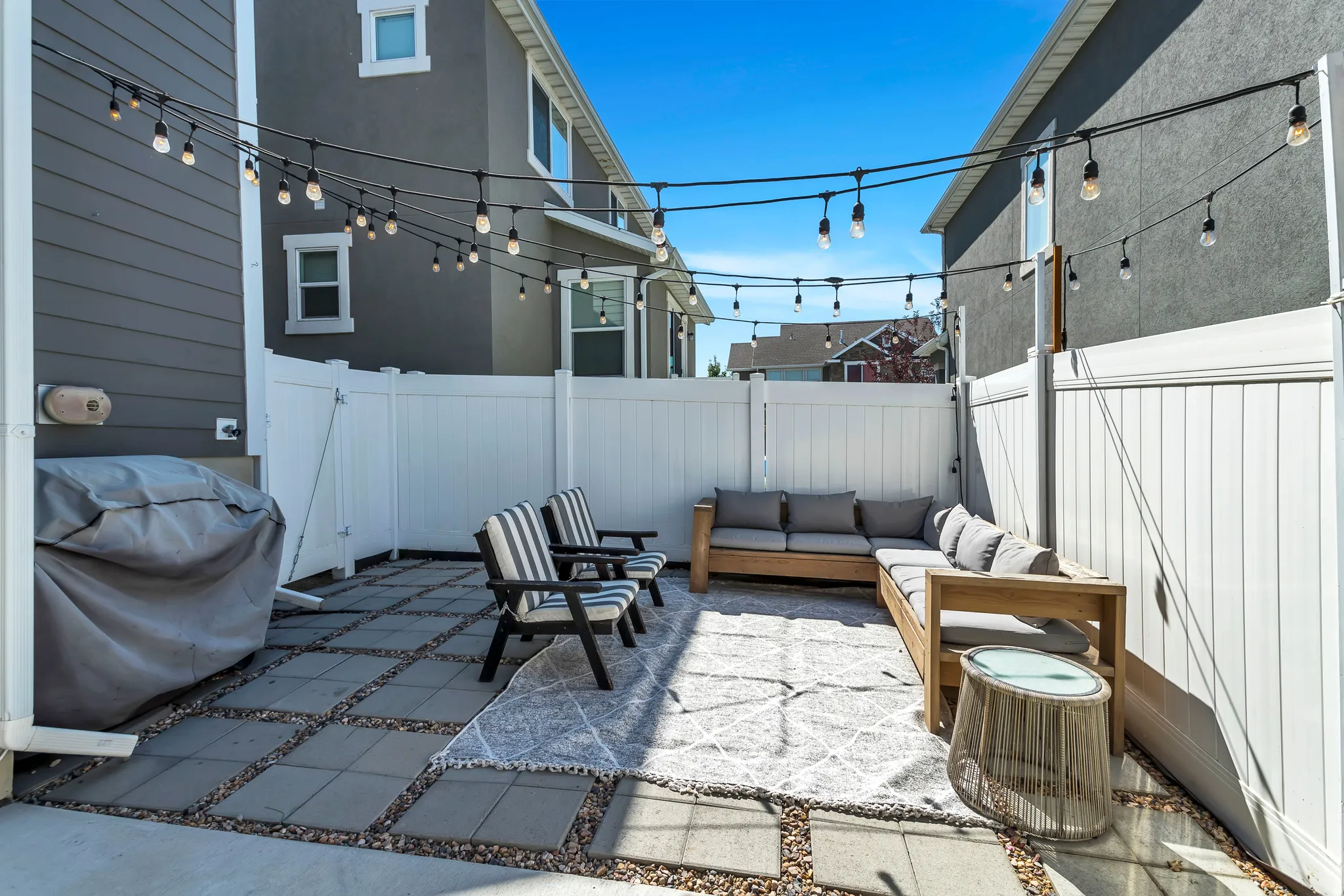 Fenced backyard featuring a patio area, area for grilling, and an outdoor lounge area