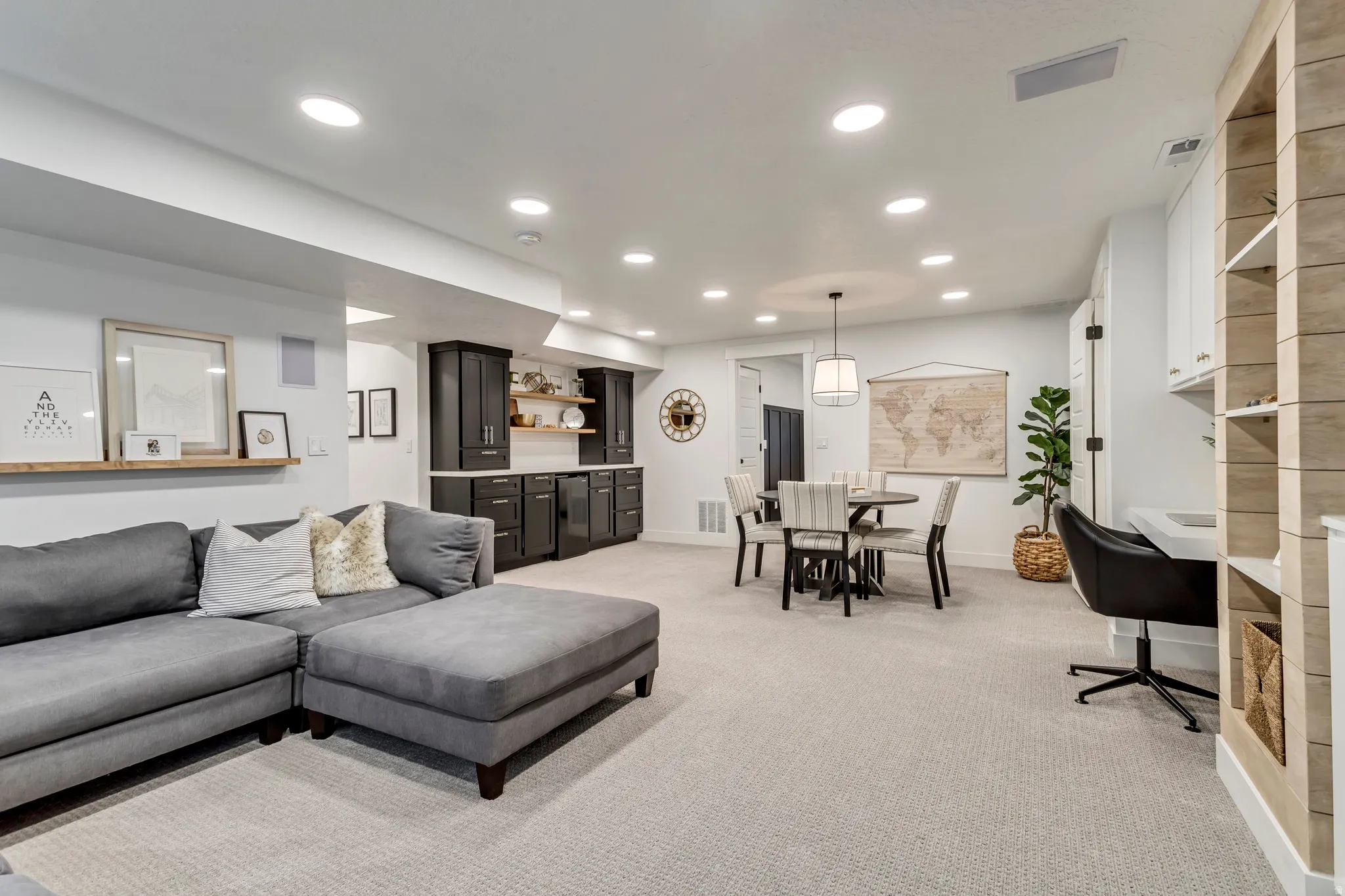 Living room featuring light carpet, recessed lighting, and built-in bar