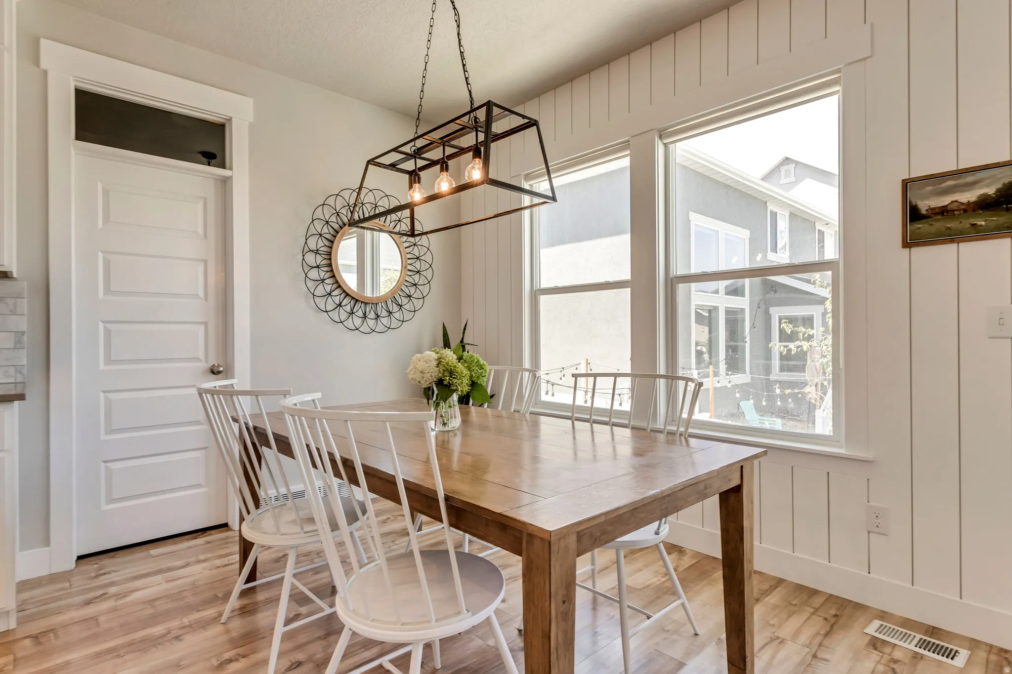 Dining area featuring light wood-style floors and vertical shiplap