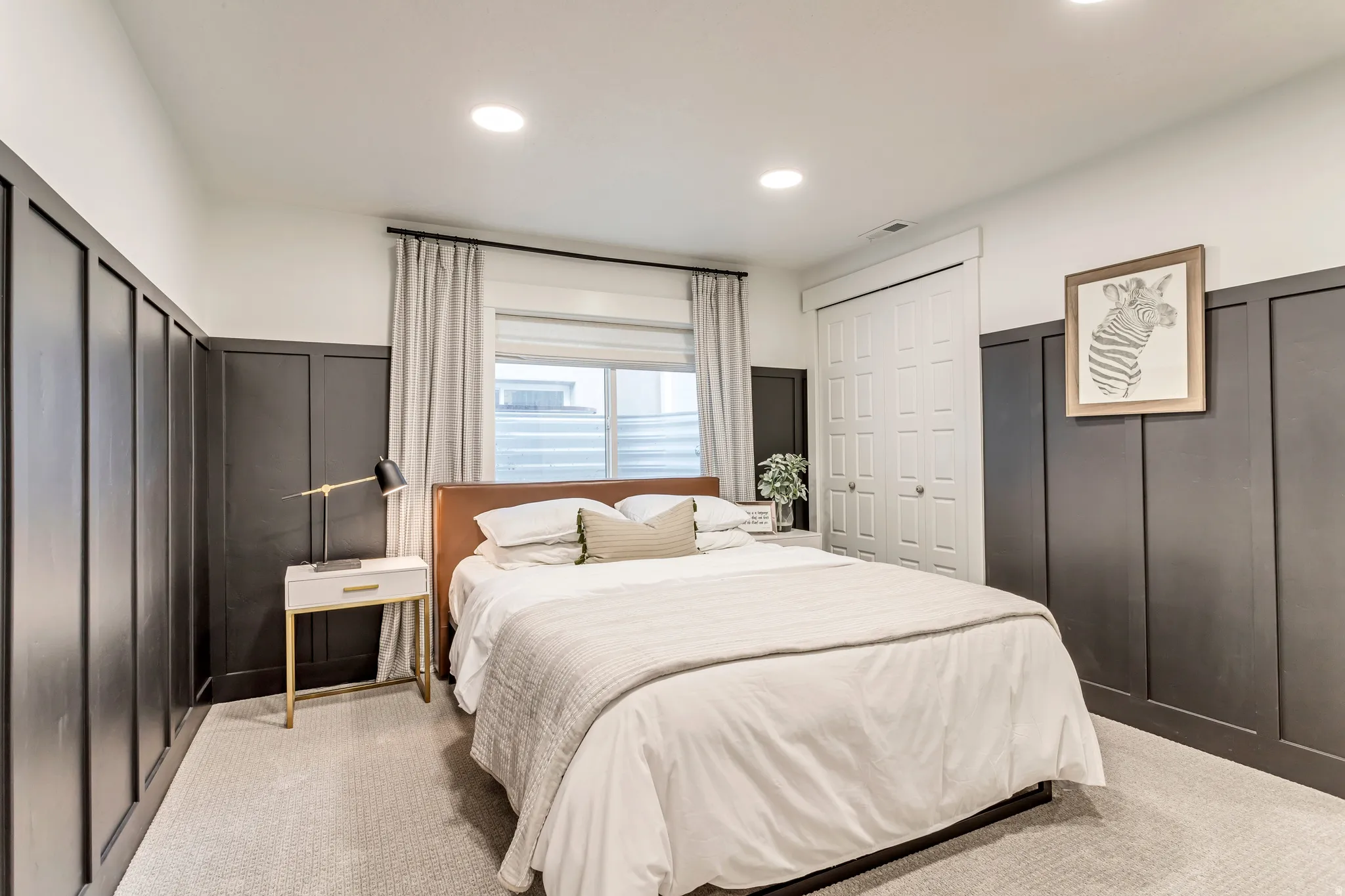Bedroom featuring a decorative wall, a wainscoted wall, light carpet, and recessed lighting