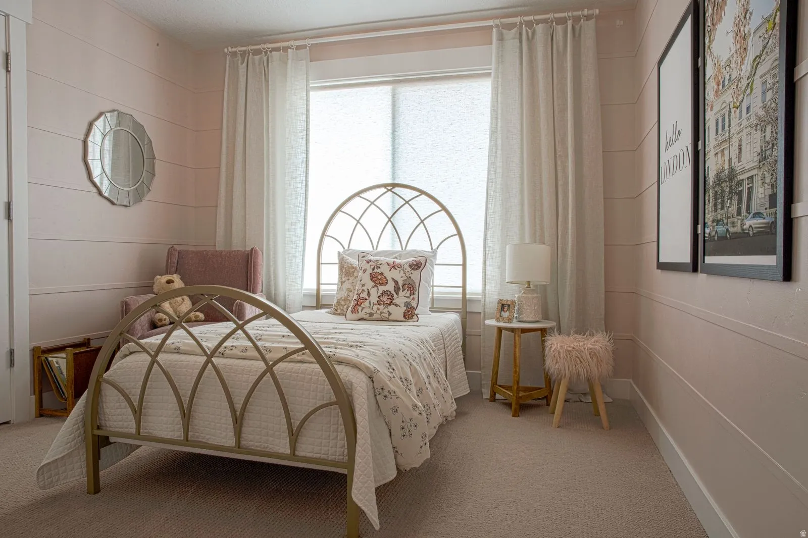 Bedroom with a textured ceiling, light carpet, and hanging lights