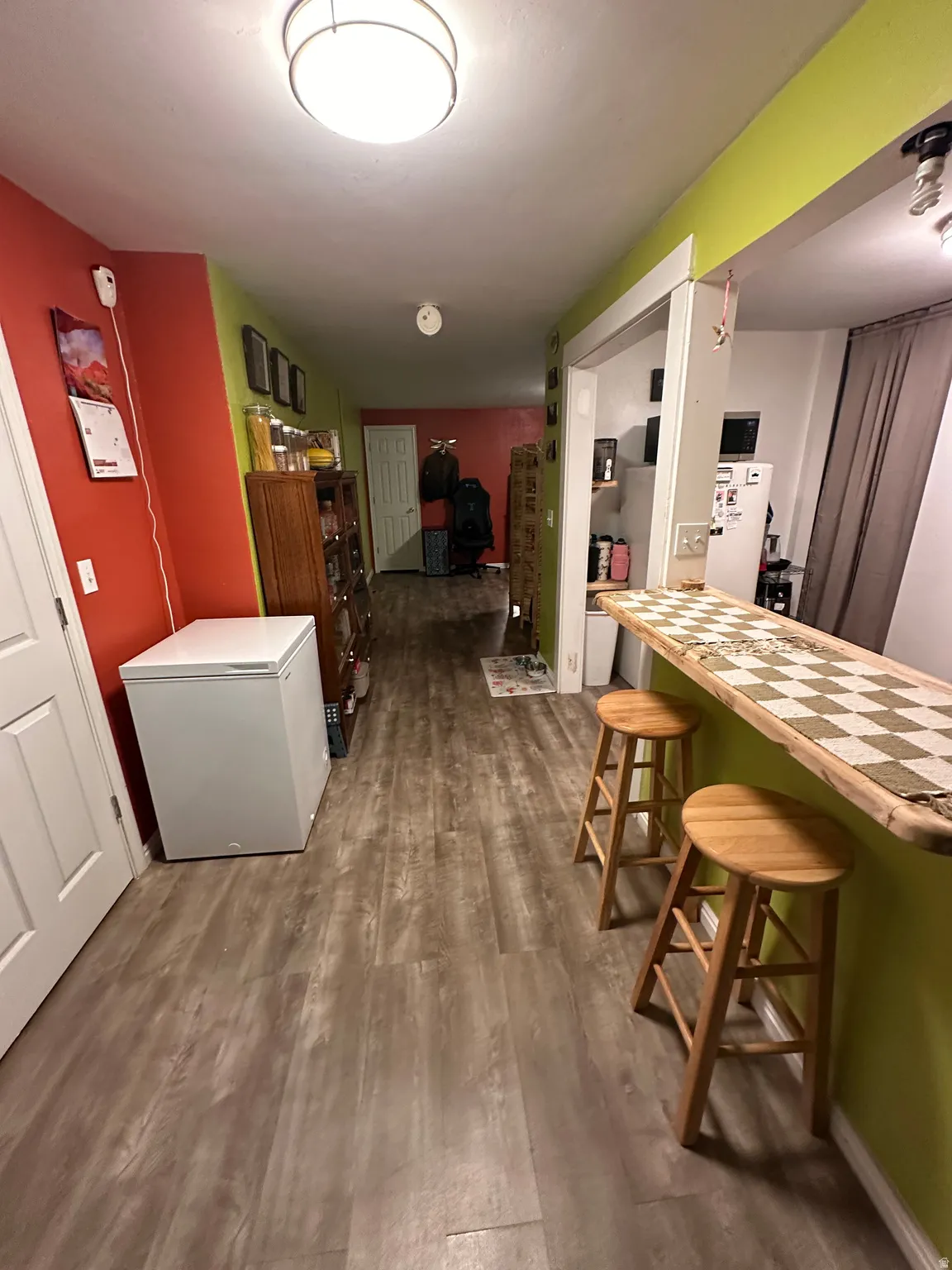 Hallway featuring dark wood-style flooring