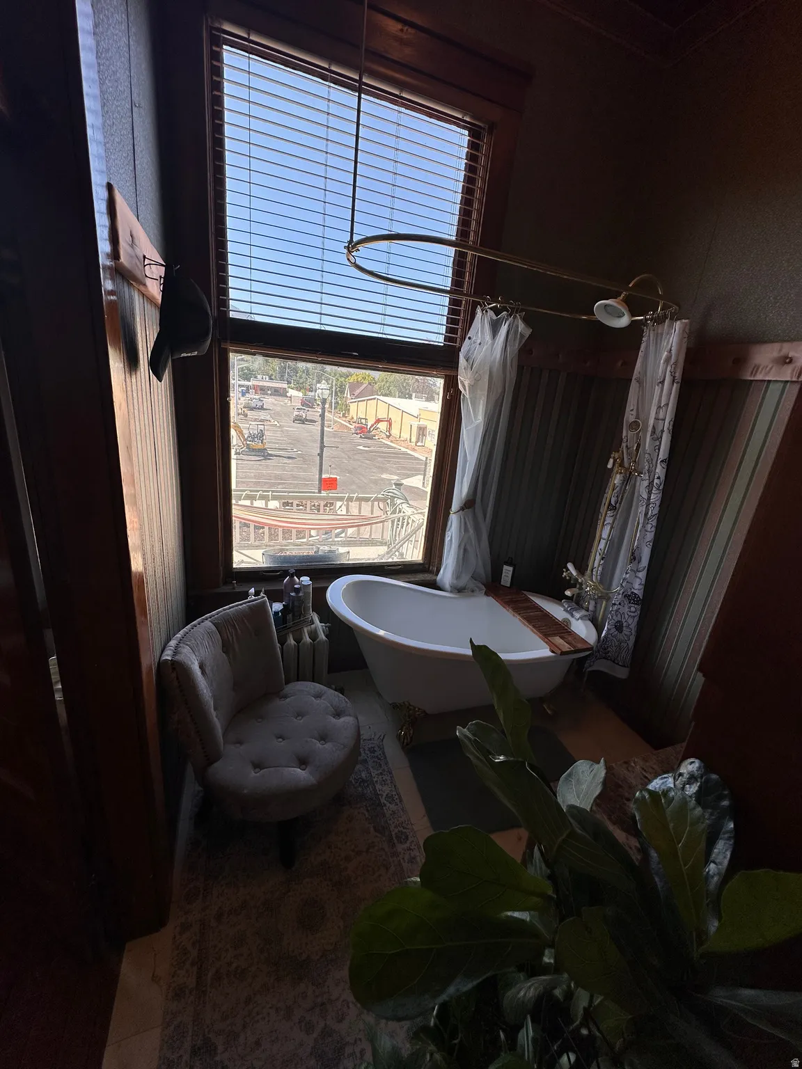 Full bathroom featuring a combined bath / shower with freestanding tub and radiator heating unit