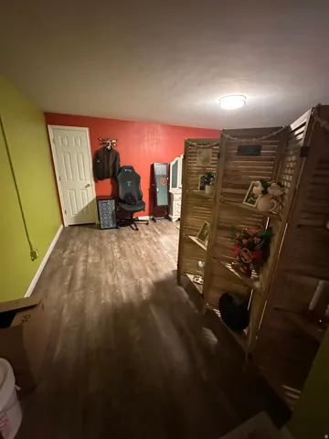 Office space with baseboards and dark wood-style flooring