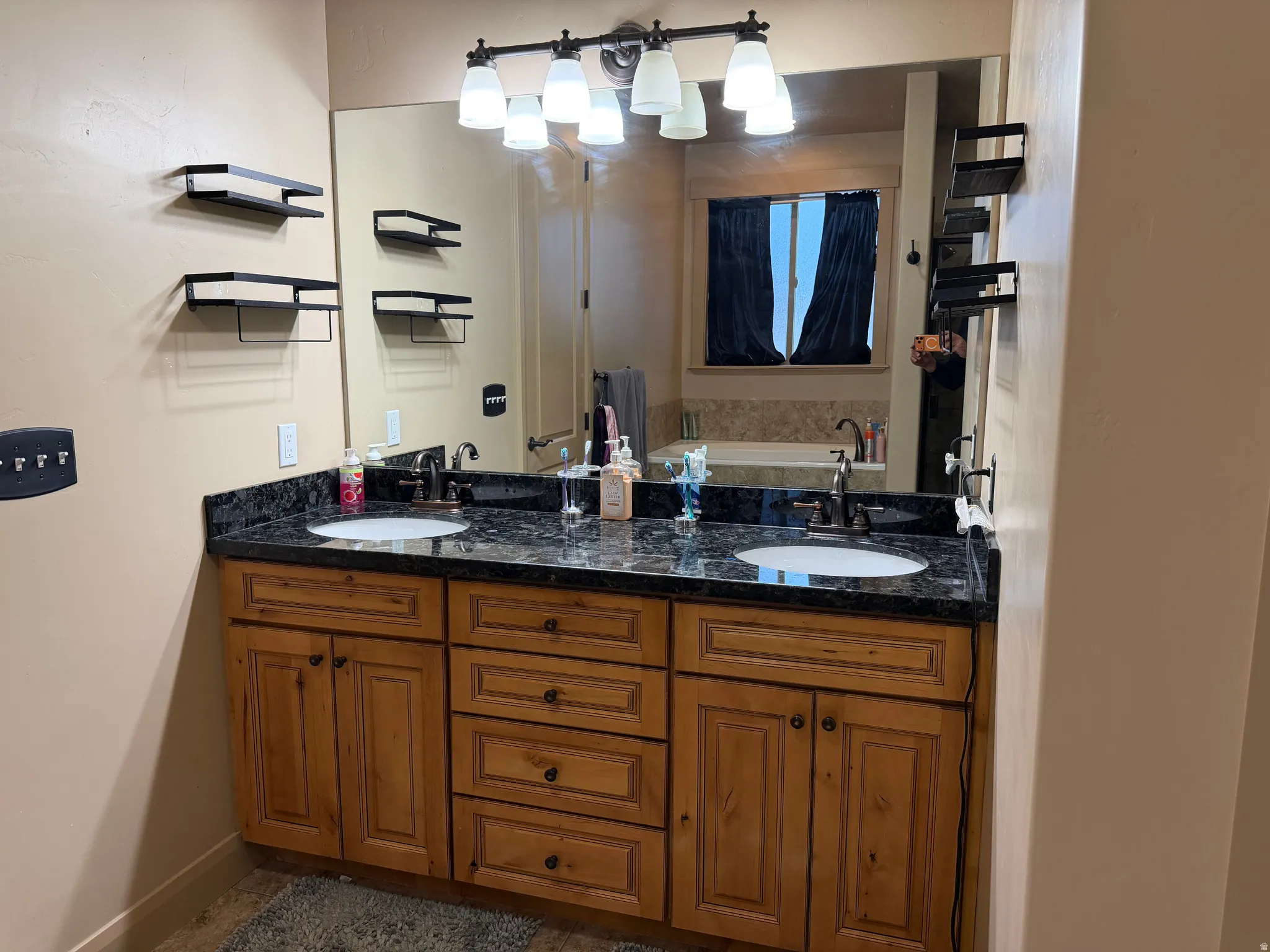 Bathroom featuring double vanity and a bath