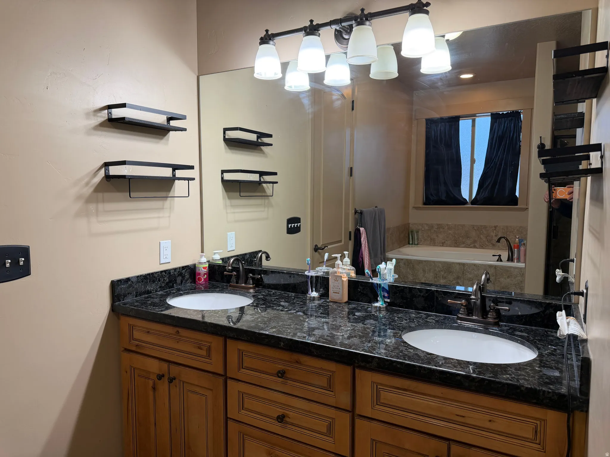 Full bath featuring double vanity and a bath