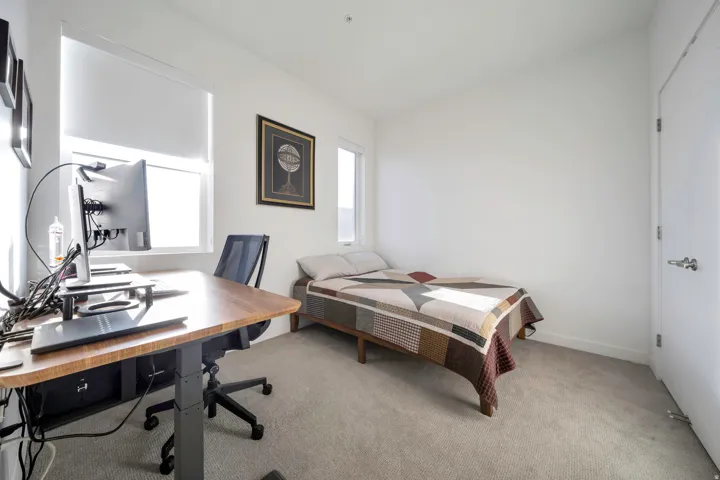 Bedroom with light colored carpet