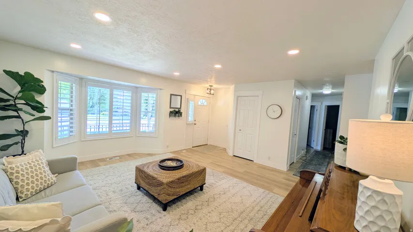 Open-concept living space with recessed lighting and light wood-finish flooring