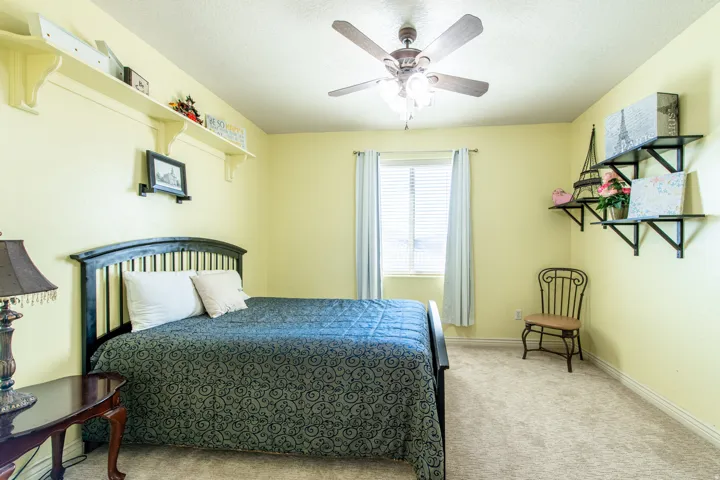 Bedroom with light carpet and ceiling fan