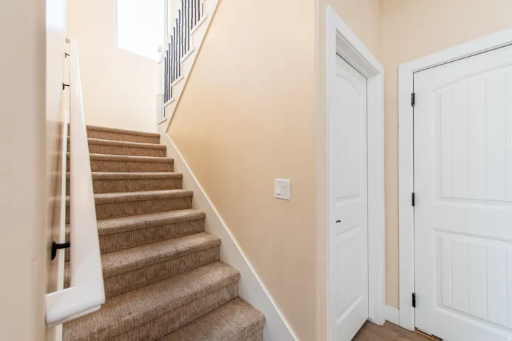 Stairs with baseboards and wood finished floors