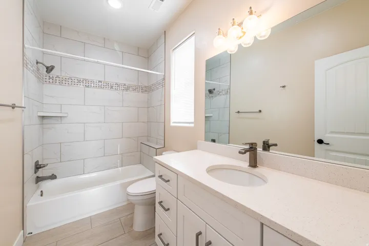 Full bath with vanity and shower / bath combination