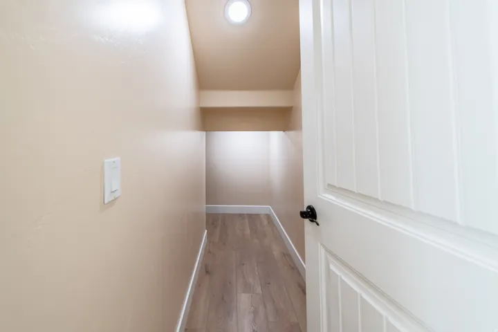 Corridor featuring baseboards and light wood finished floors