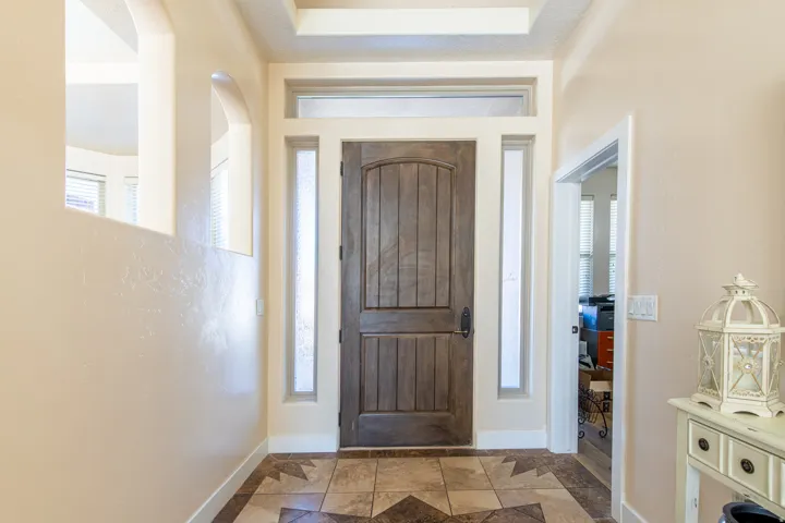 Entryway with inlaid floor details and plenty of natural light