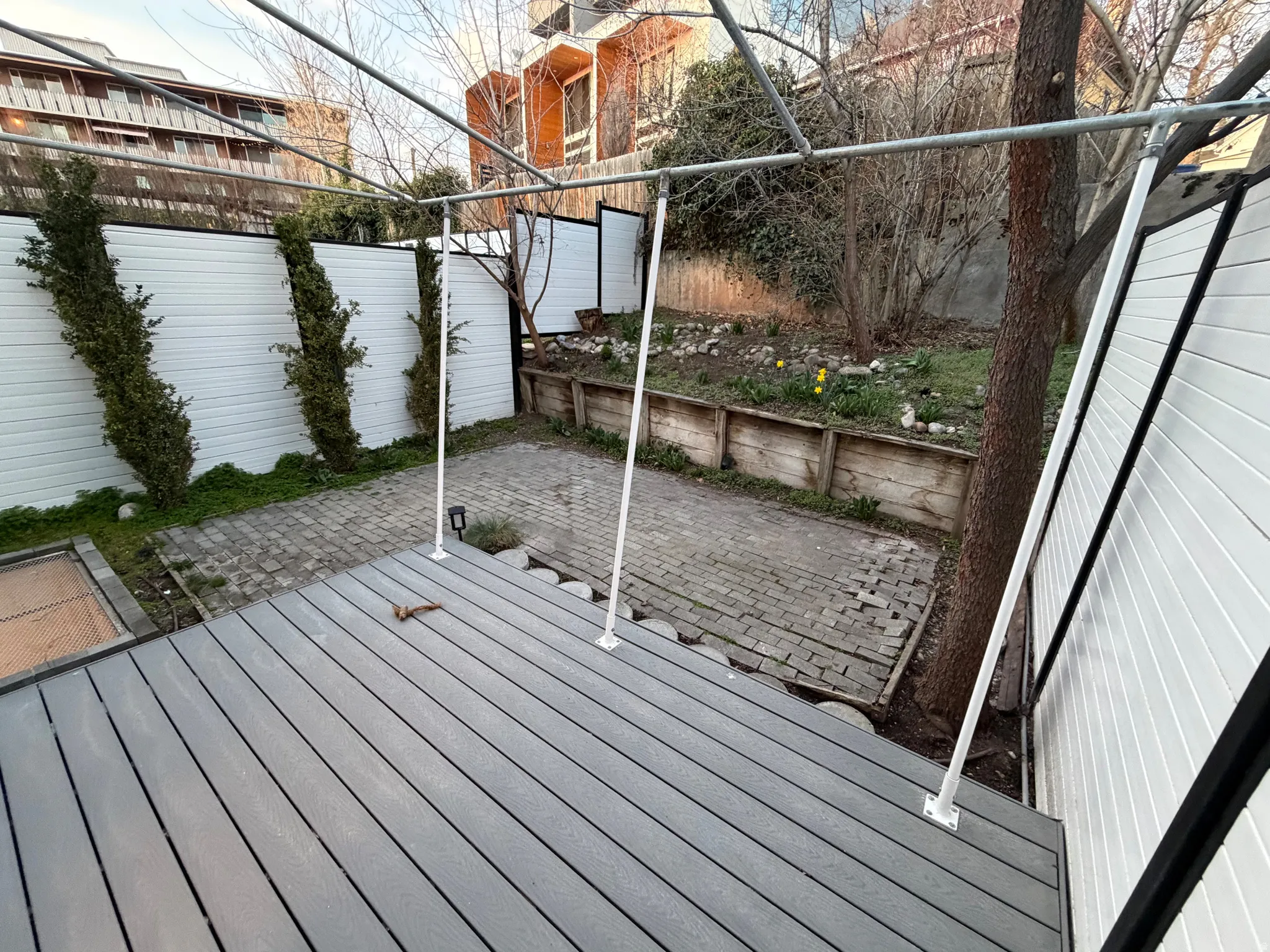 Wooden terrace featuring a fenced backyard