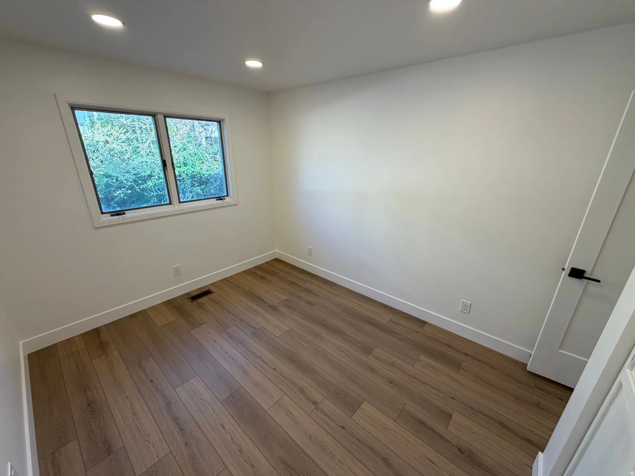 Unfurnished room featuring dark wood finished floors and recessed lighting