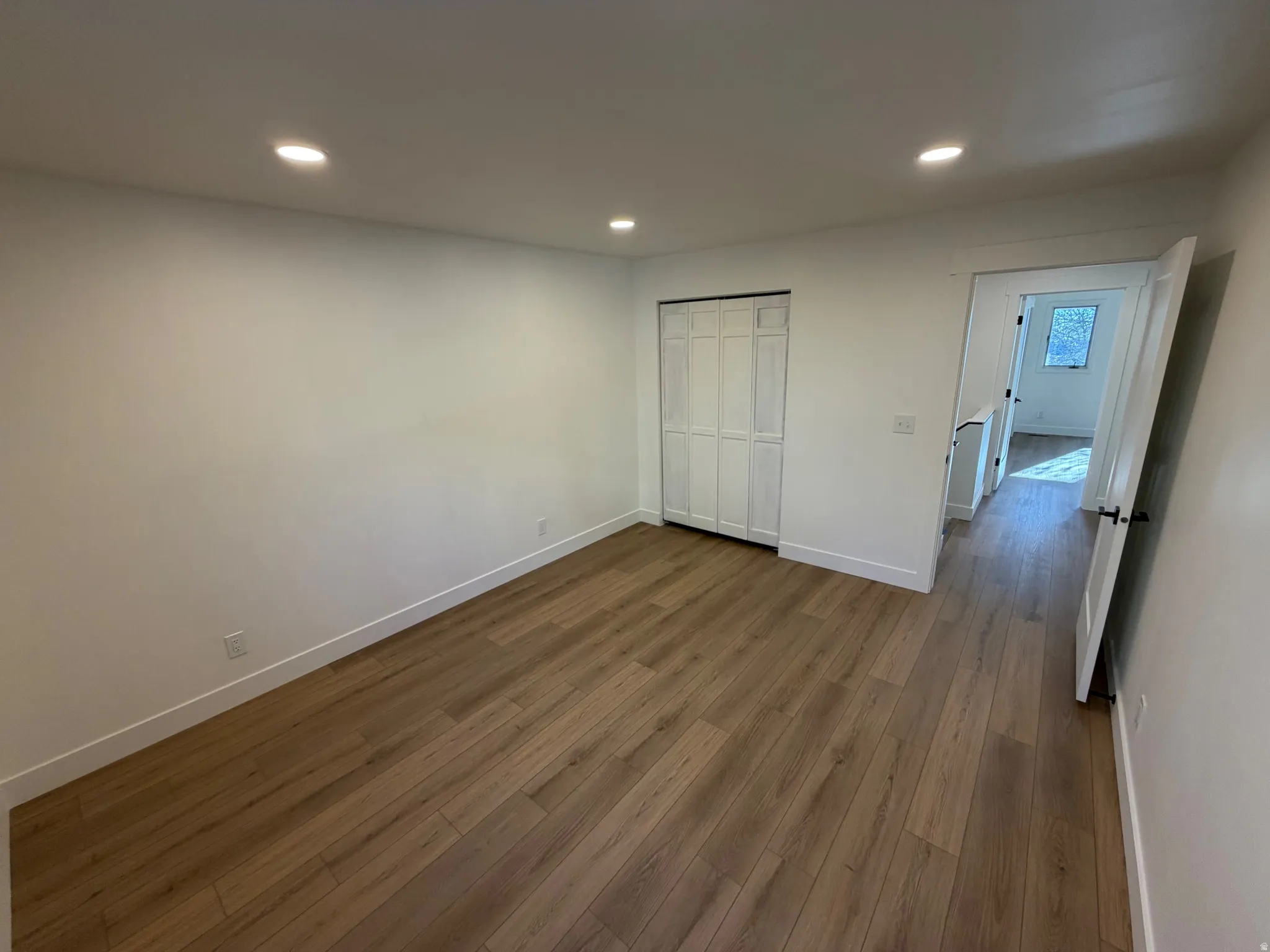 Unfurnished bedroom with dark wood finished floors, recessed lighting, and a closet
