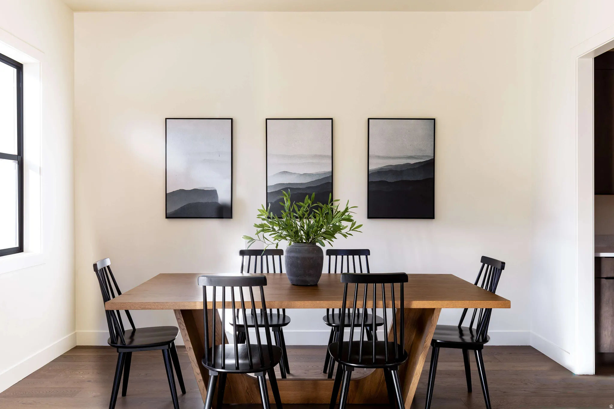 Dining room with dark wood-type flooring and baseboards