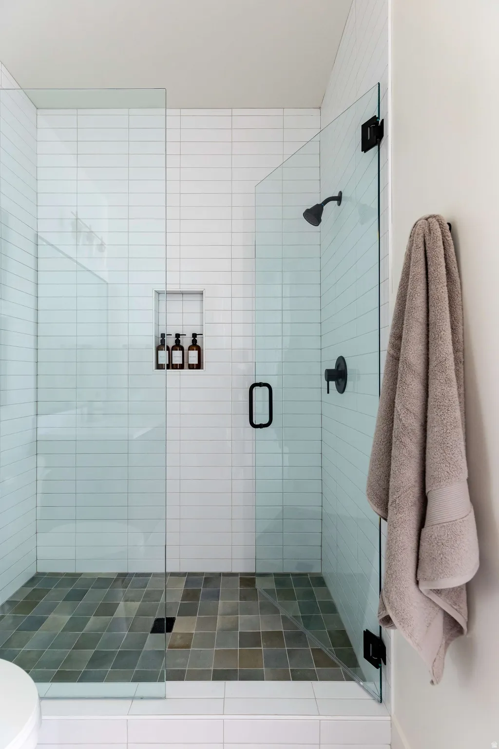 Bathroom featuring a stall shower and toilet