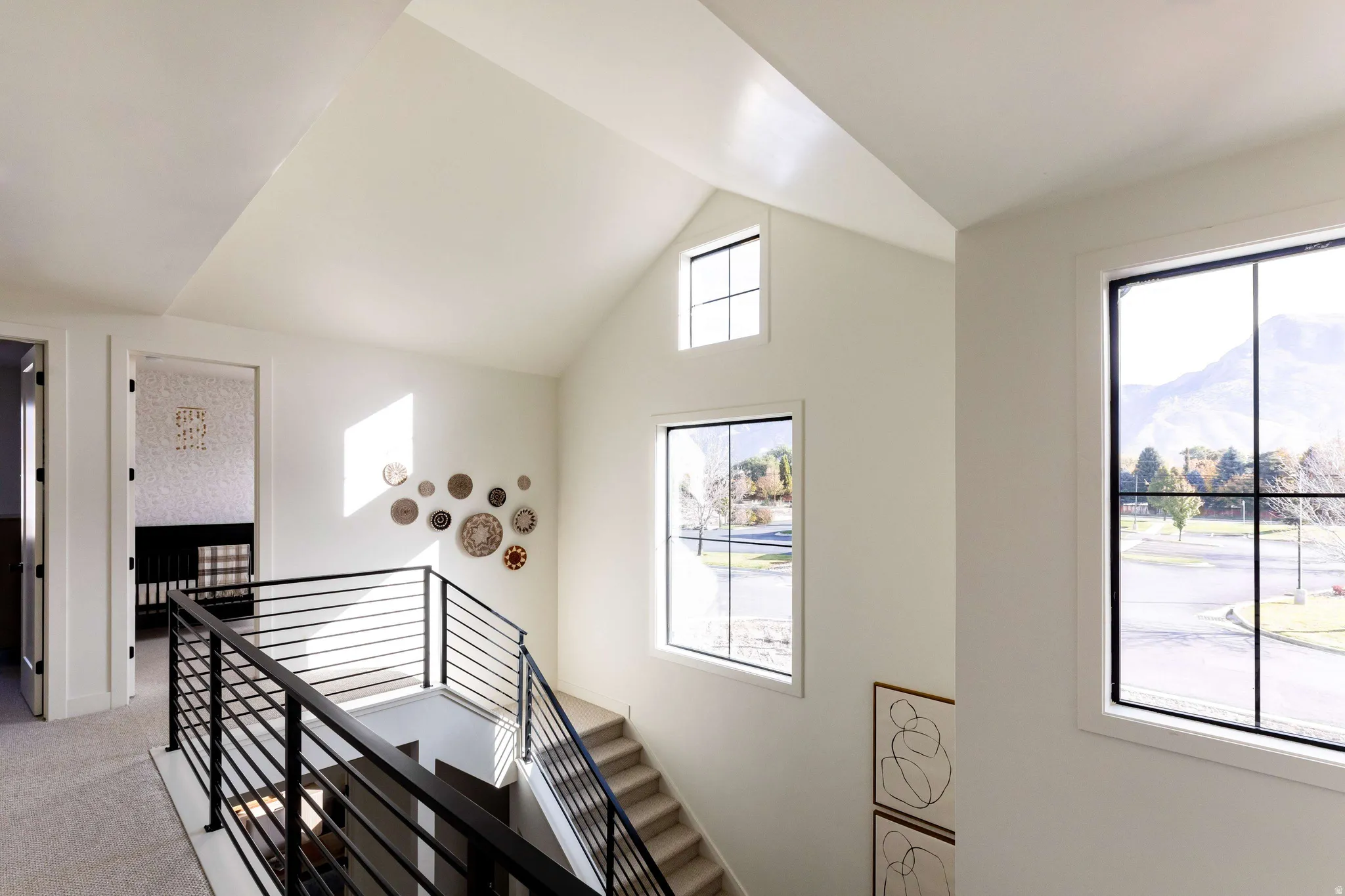 Staircase featuring carpet floors and a mountain view