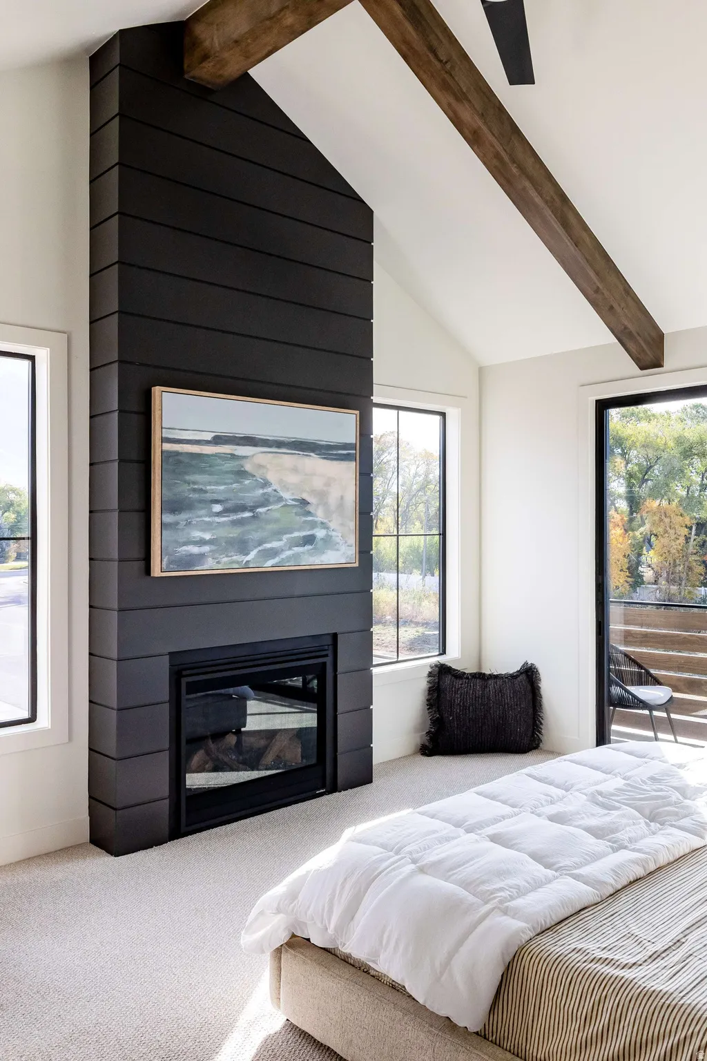 Bedroom featuring carpet flooring, access to outside, a fireplace, and lofted ceiling
