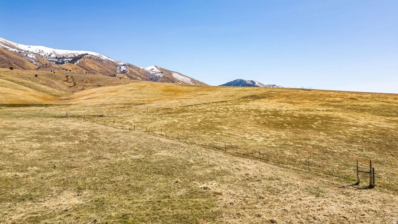 View of mountain backdrop with rural landscape