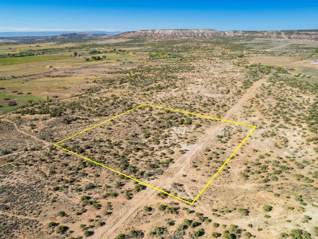 Overview of rural landscape featuring property boundaries highlighted and a mountain backdrop