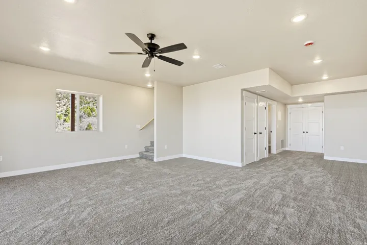 Spare room with carpet flooring, ceiling fan, and recessed lighting