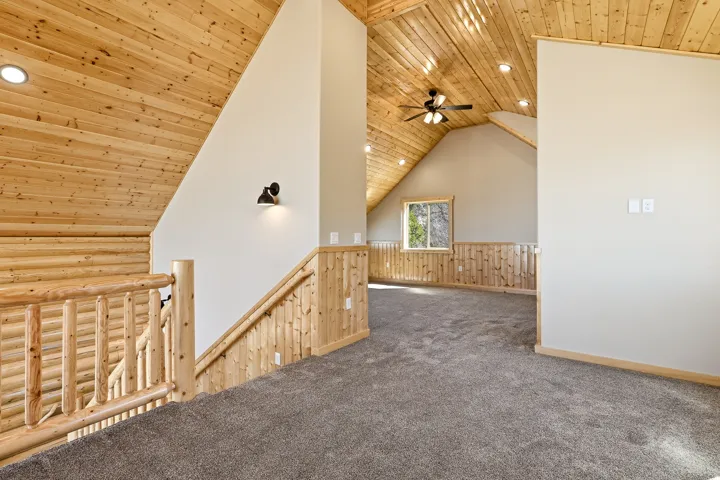 Bonus room featuring a vaulted wood ceiling, a wainscoted wall, recessed lighting, carpet, and wooden walls