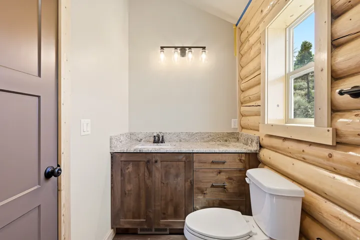 Bathroom featuring vanity and log walls