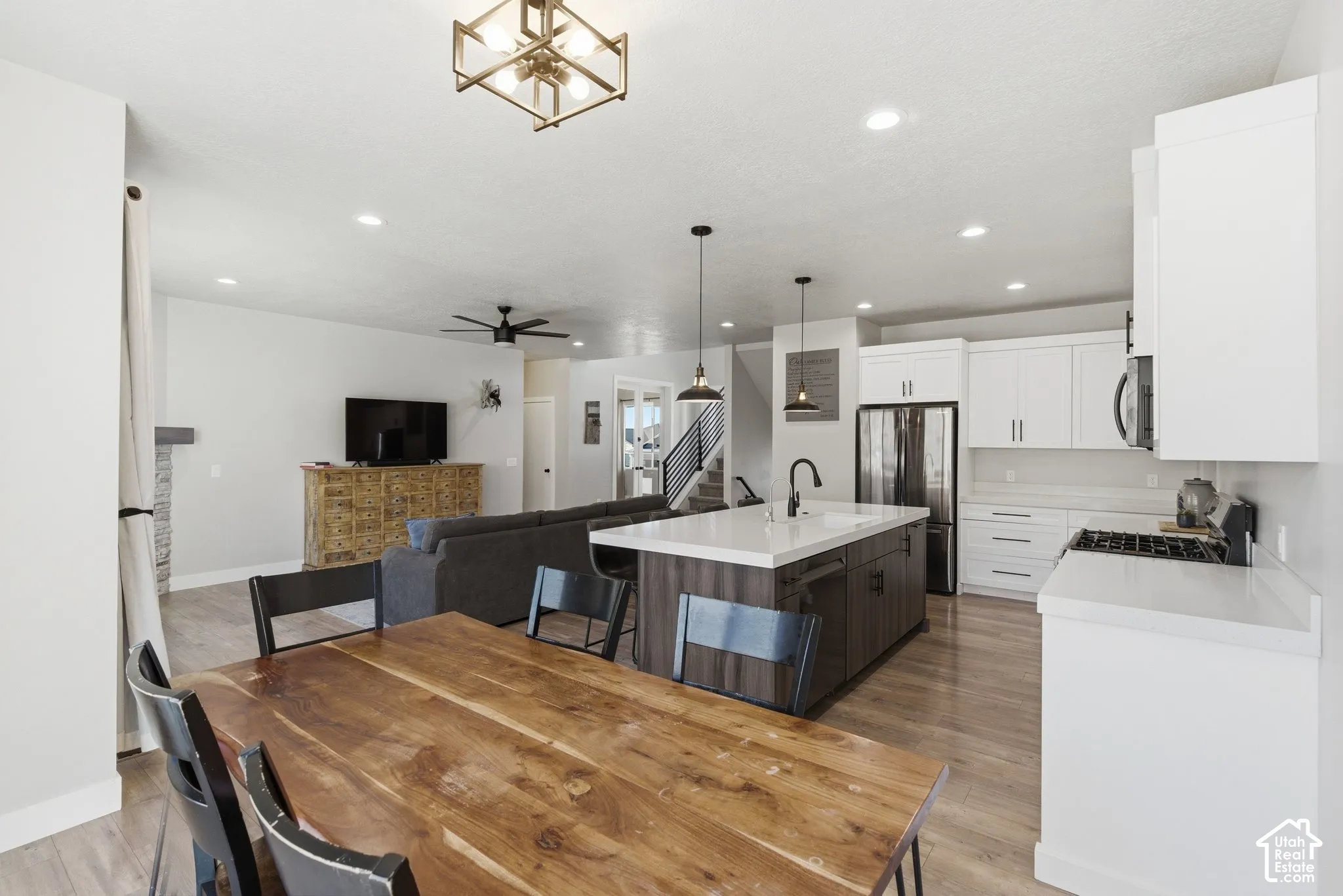 Dining room with light wood-style flooring, recessed lighting, and ceiling fan