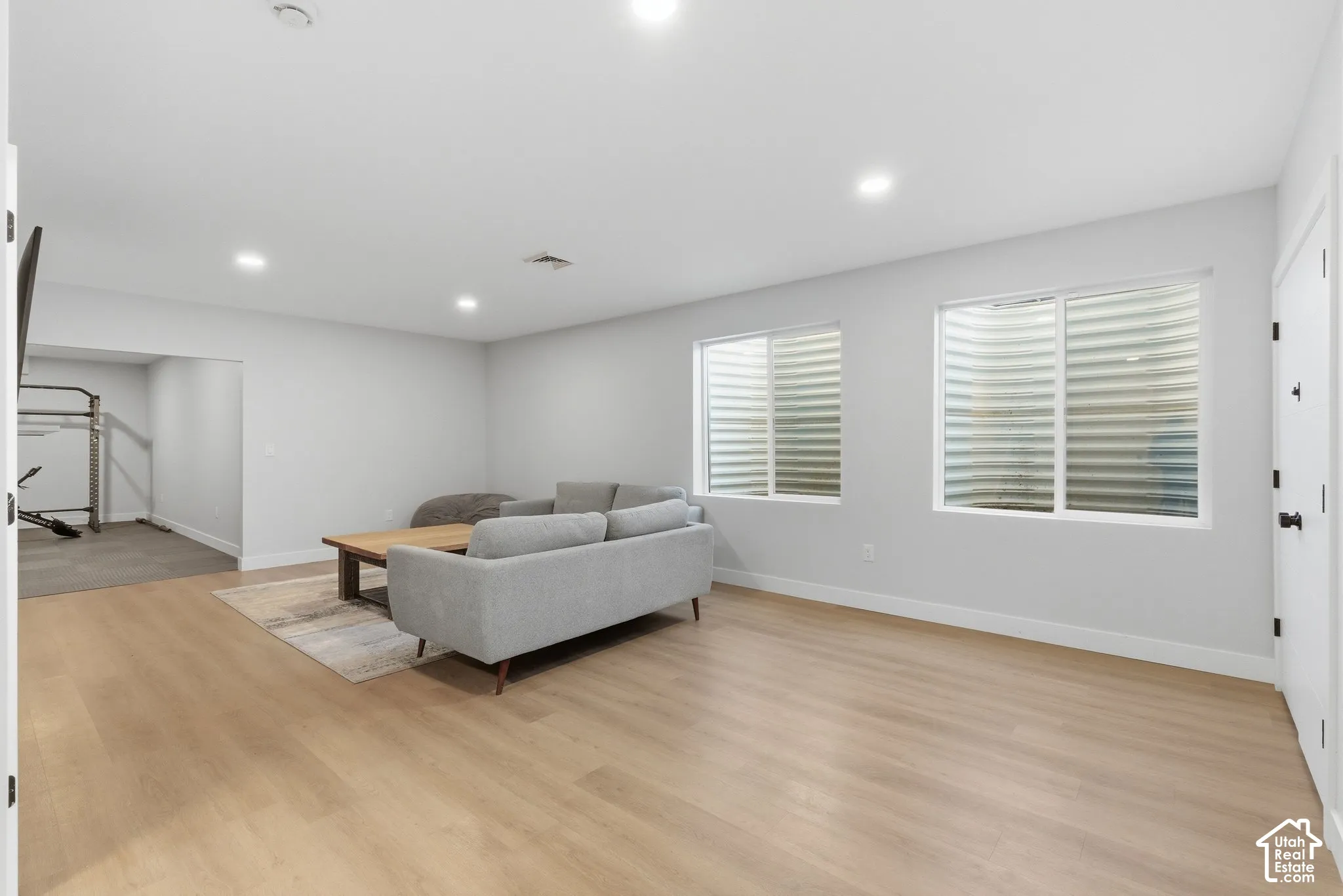 Living room featuring light wood-type flooring and recessed lighting