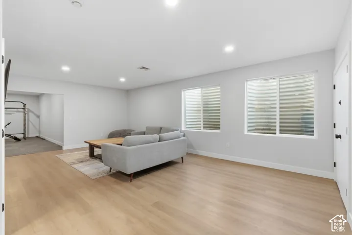 Living room featuring light wood-type flooring and recessed lighting