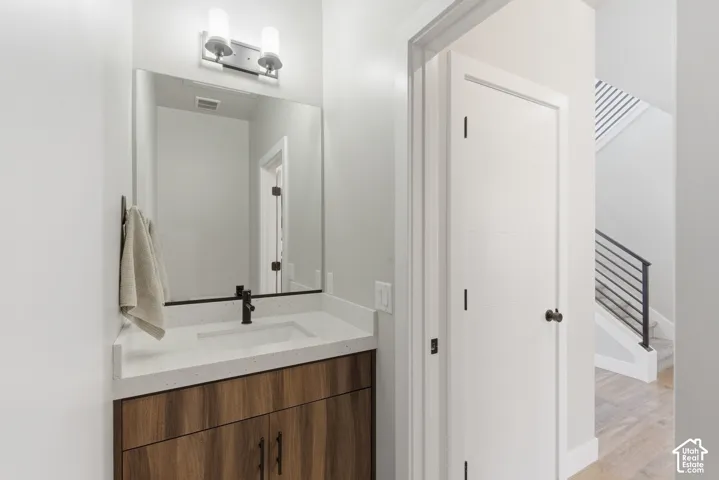 Guest Bathroom featuring vanity and light wood-type flooring