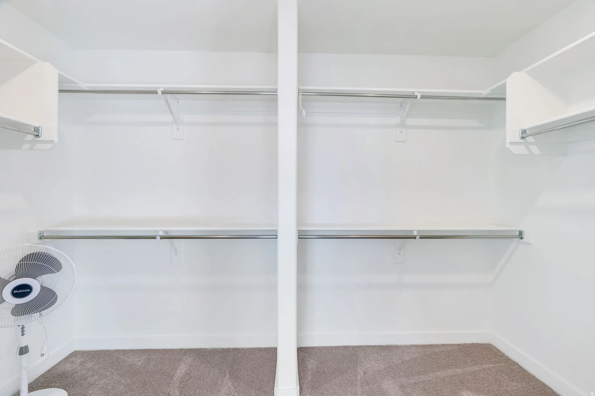 Walk in closet featuring light carpet