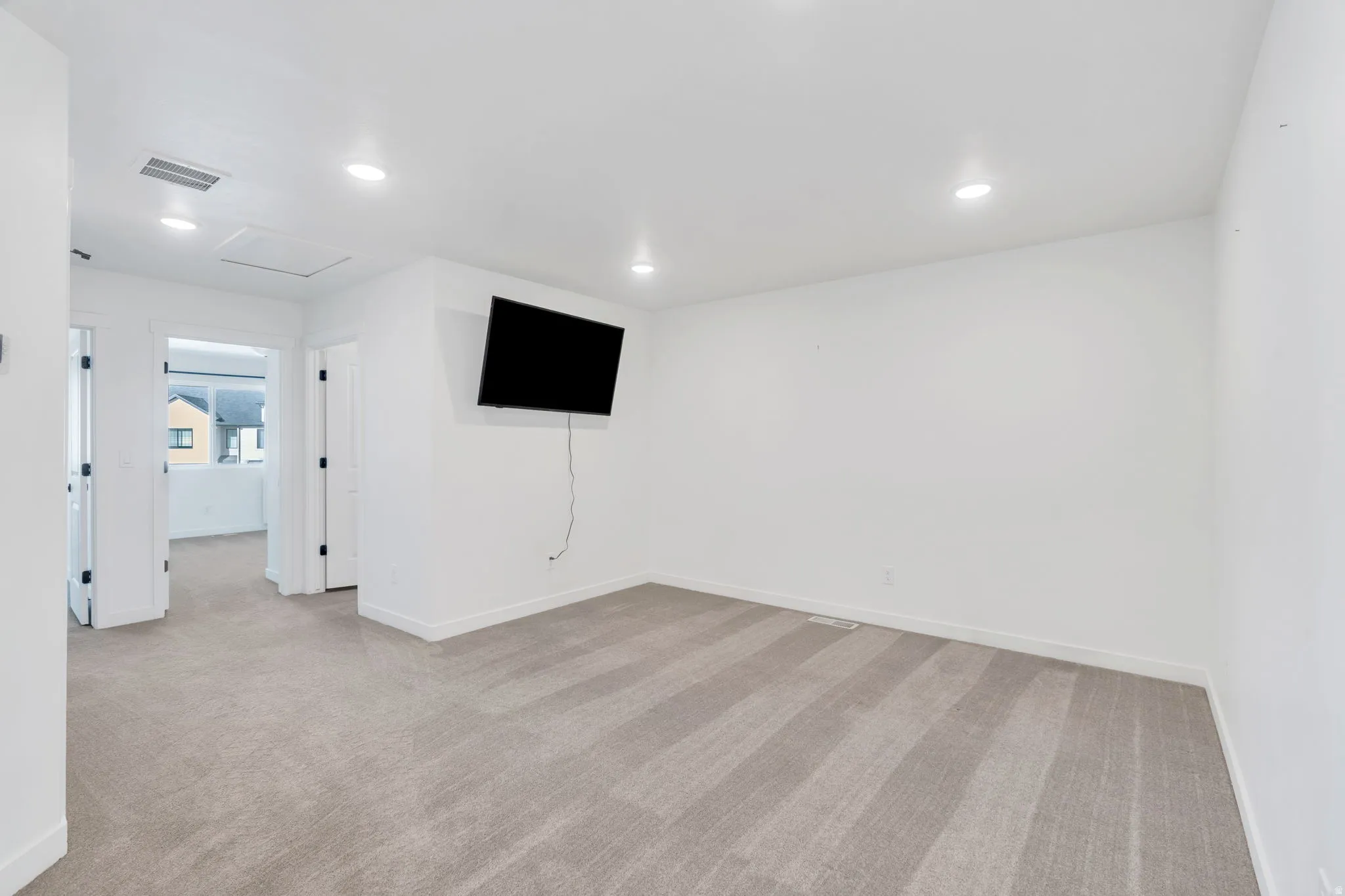 Unfurnished room with light carpet and recessed lighting