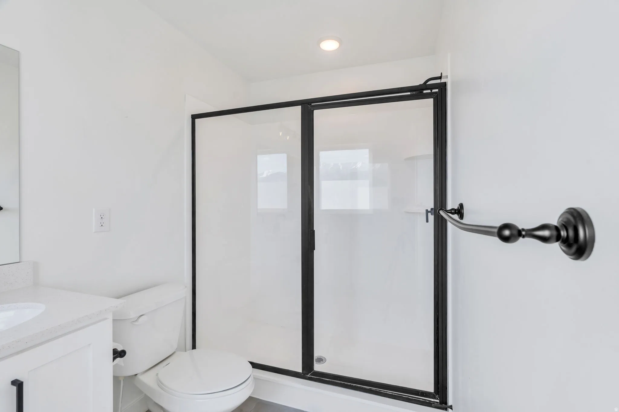 Bathroom with vanity and a stall shower