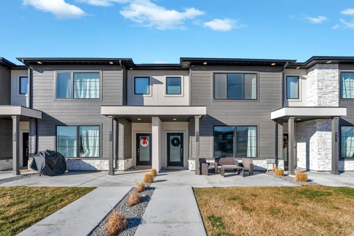 Contemporary house with stone siding and a front yard
